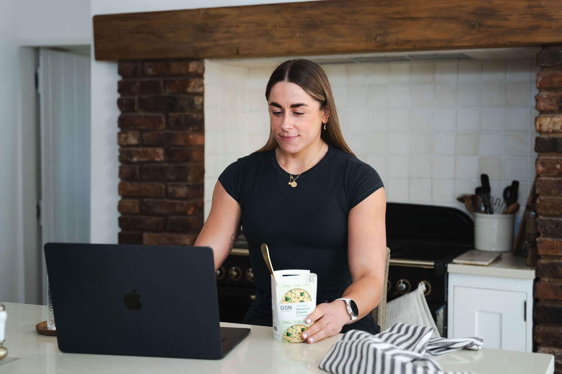 working from the kitchen counter whilst eating a high protein ready meal from GSN